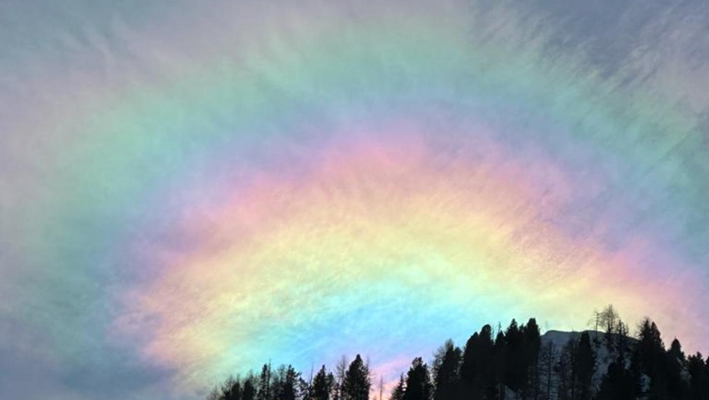 Spectacular Celestial Ballet: Iridescent Clouds Paint the Sky in Arabba