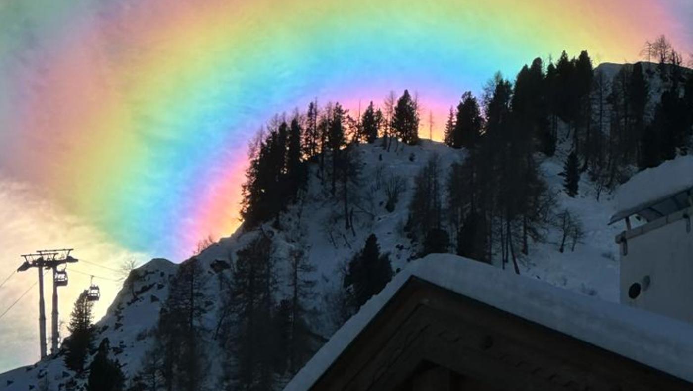 Spectacular Celestial Ballet: Iridescent Clouds Paint the Sky in Arabba