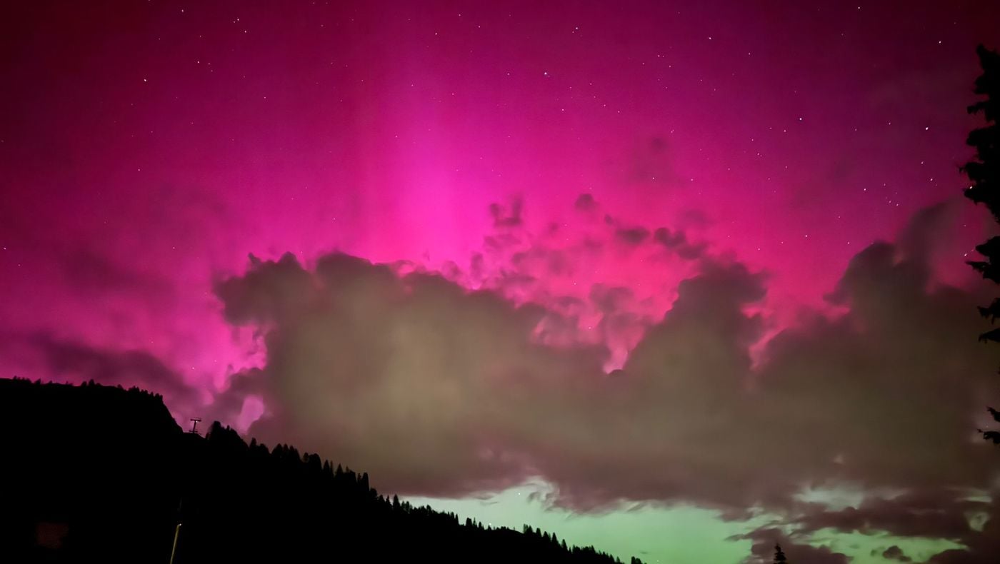 Enchantment of pink light: Northern lights in the Dolomites