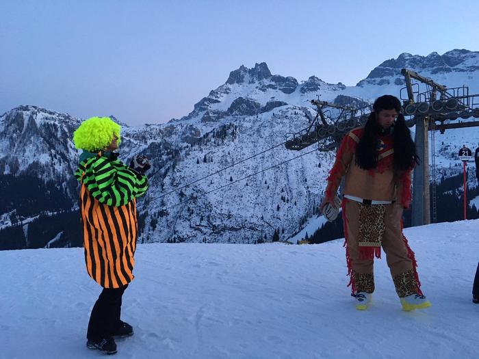 Masked torchlight descent with ski instructors